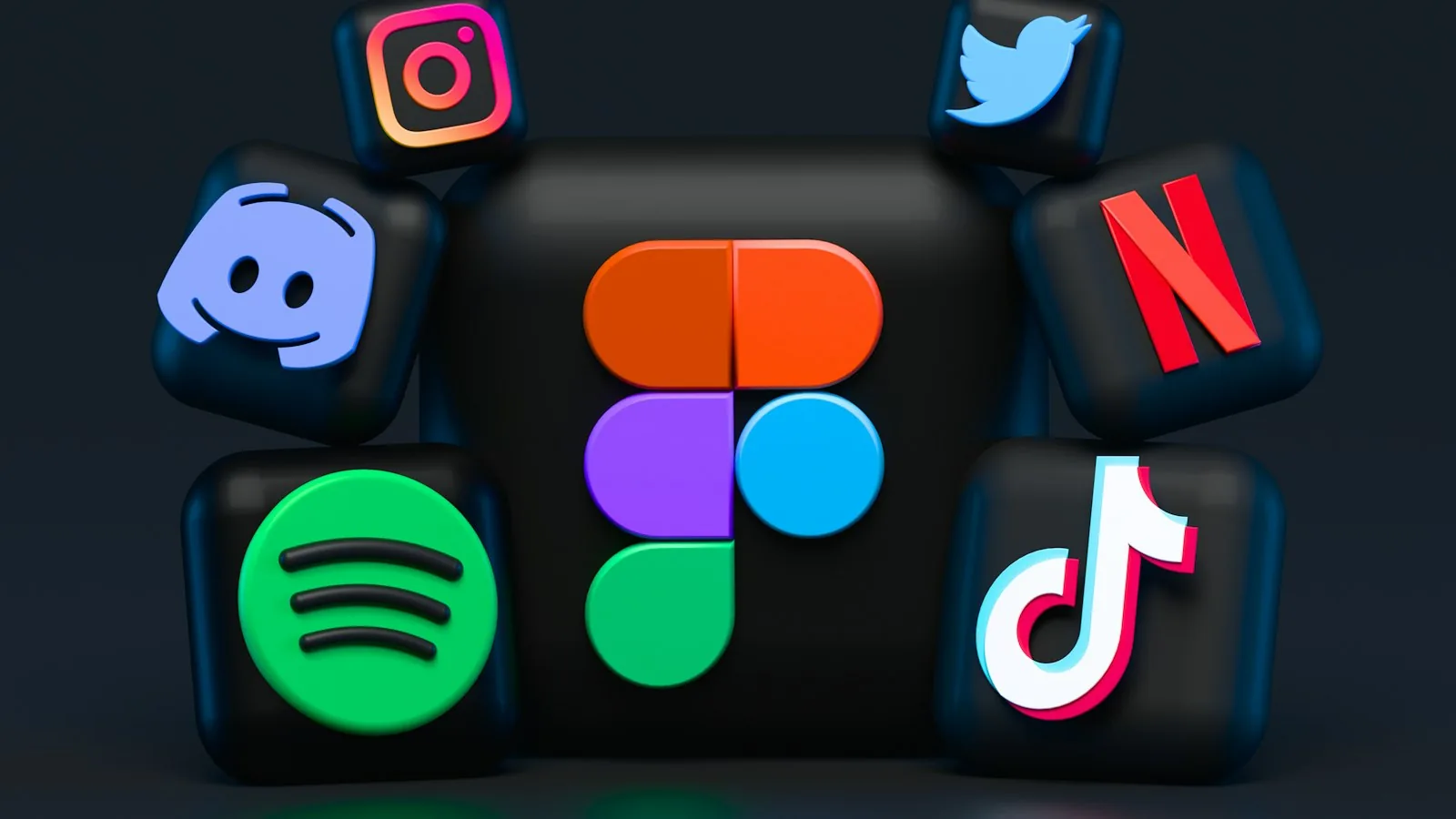 Three-dimensional icons of social apps stacked on a dark cube
